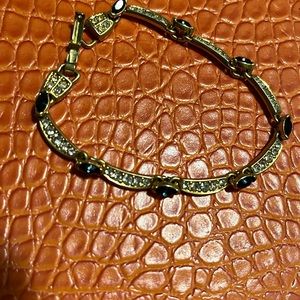 Gold bracelet with blue and clear jewels